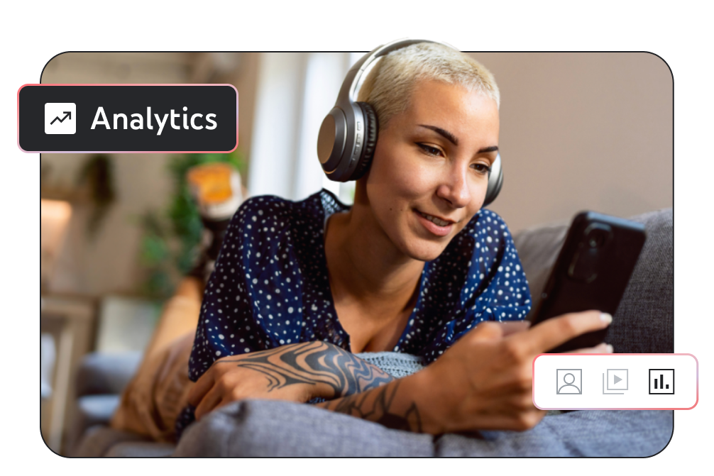 Image of a person wearing headphones, laying on their sofa, and looking at their phone with the word ‘Analytics’ in the corner of the screen.